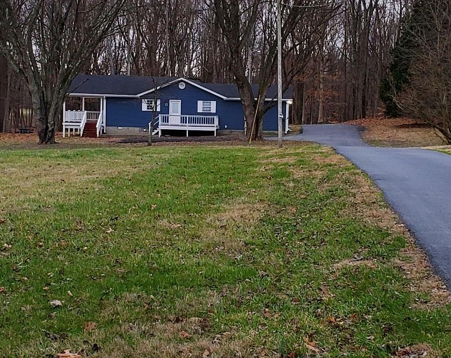 Set back off road, paved driveway to house.