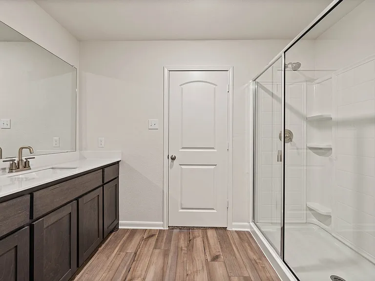 The master bathroom has a glass, walk-in shower.