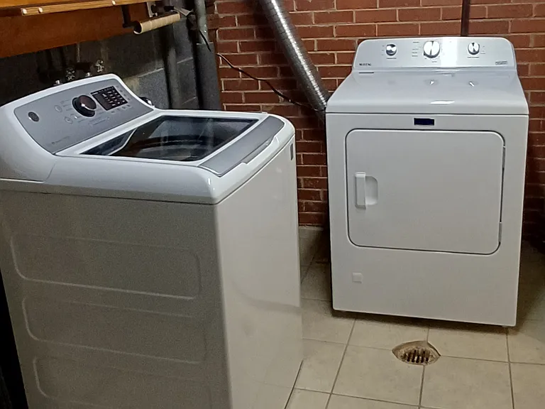 Utility sink between washer and brand new drier. Adjacent to family room.
