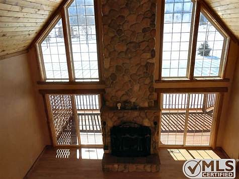 Wall of windows River Rock Fireplace LVR