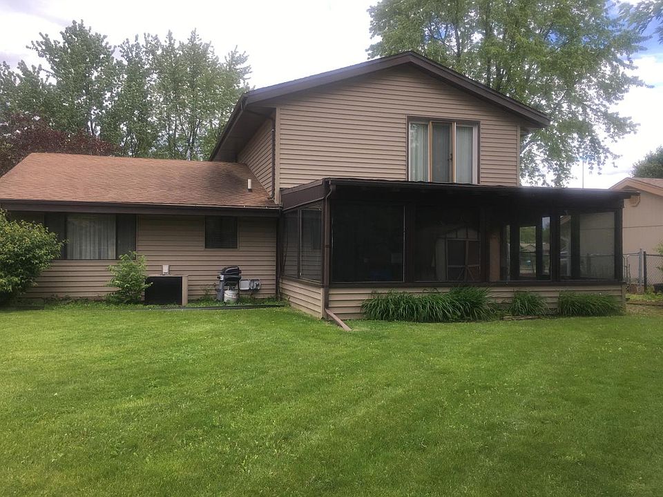 Back of house with sunroom addition