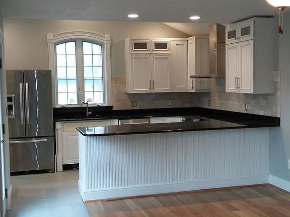 Spacious gourmet kitchen with stainless steel refrigerator