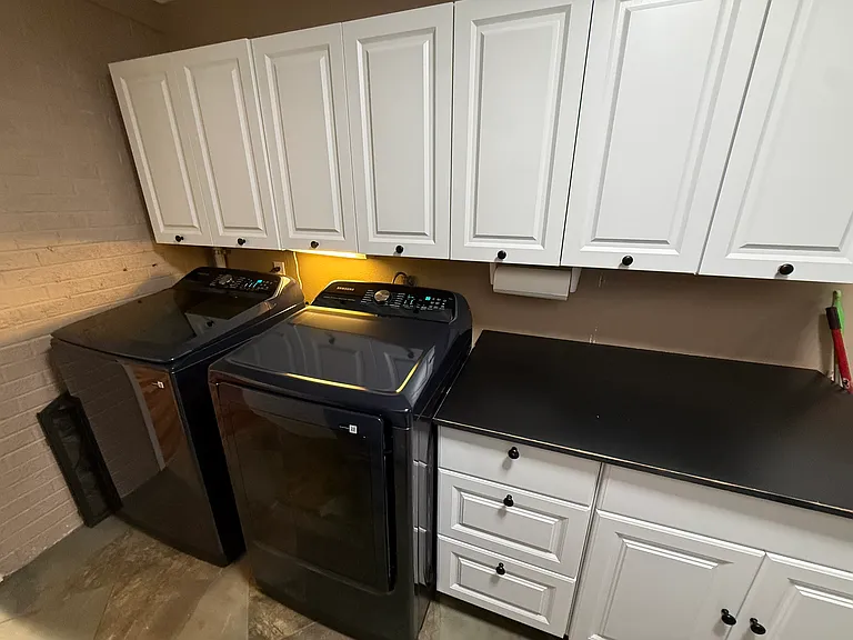 Laundry with new toploading washer and dryer and tons of storage