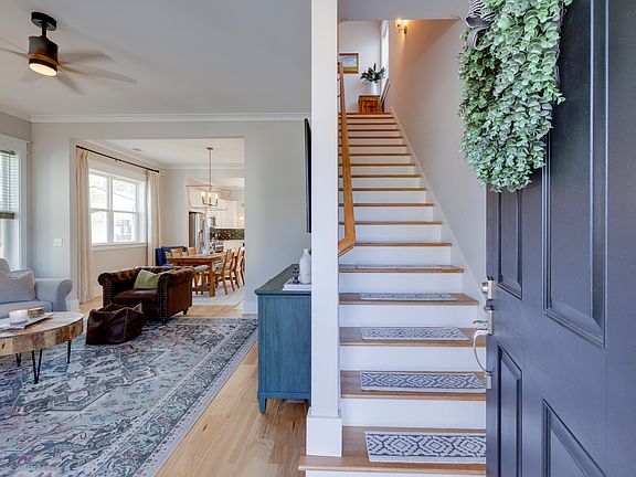 Entryway into the home (living room on left, upstairs bedrooms and full bath on right).