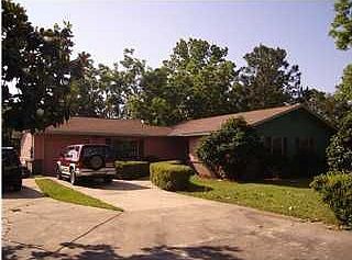 Front of the home has custom landscaping and curb appeal