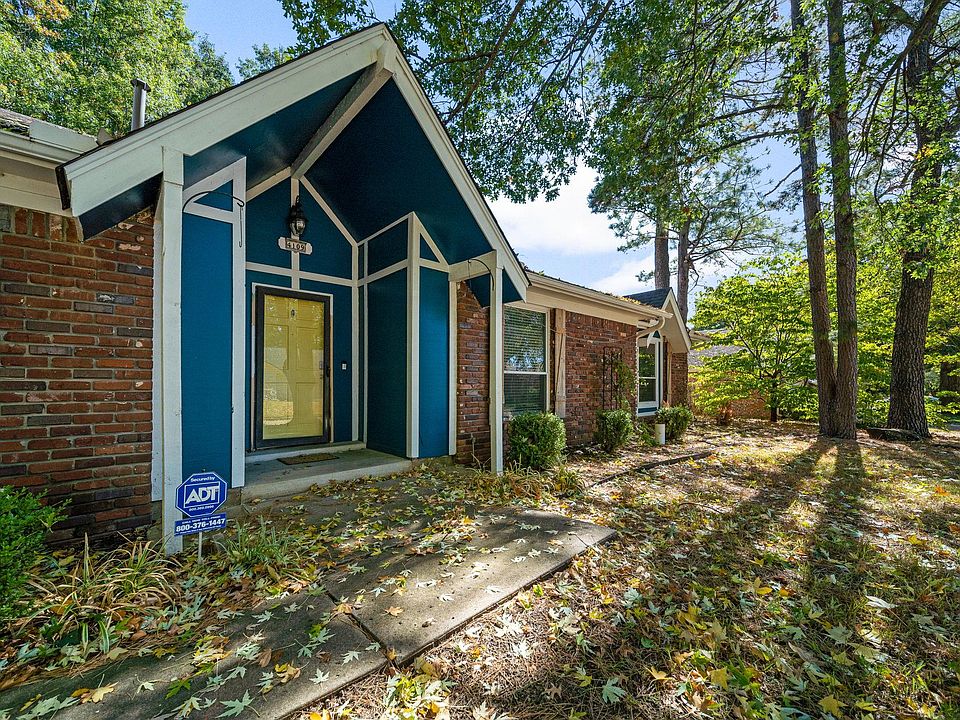 Beautiful curb appeal with charming front door and mature trees