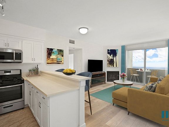 Open-Concept Kitchen, Dining, and Living Room Space with Patio