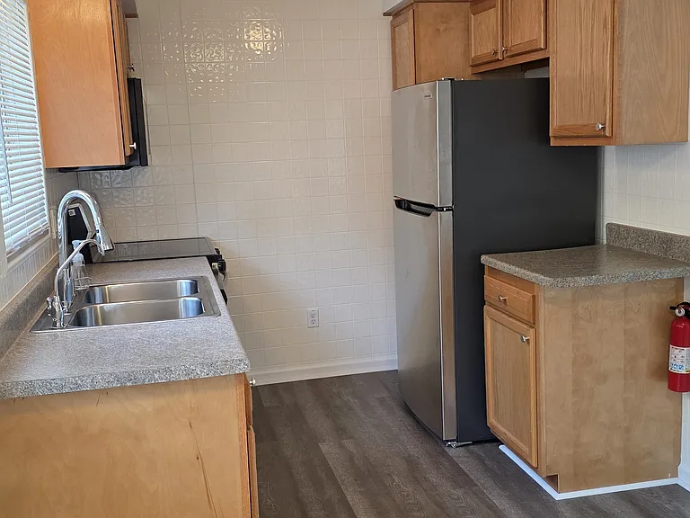 Additional cabinetry and counter space provide convenient kitchen storage.