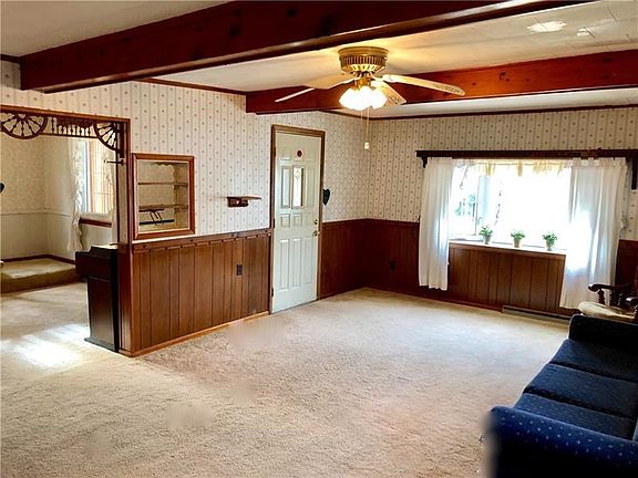 Step inside to the massive living room complete with beam ceilings and large bay window.