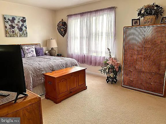 Bedroom #1 on the upper floor, with window opening to the front (West side) and the park side.
