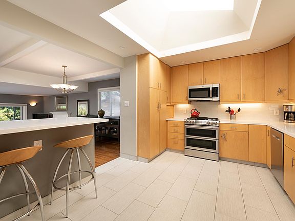 Updated kitchen with quartz countertops and newer stainless steel appliances.