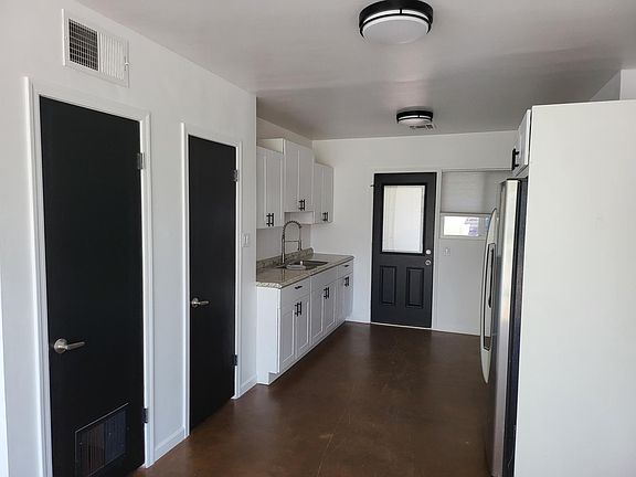 Kitchen with walk-in pantry and additional utility closet.