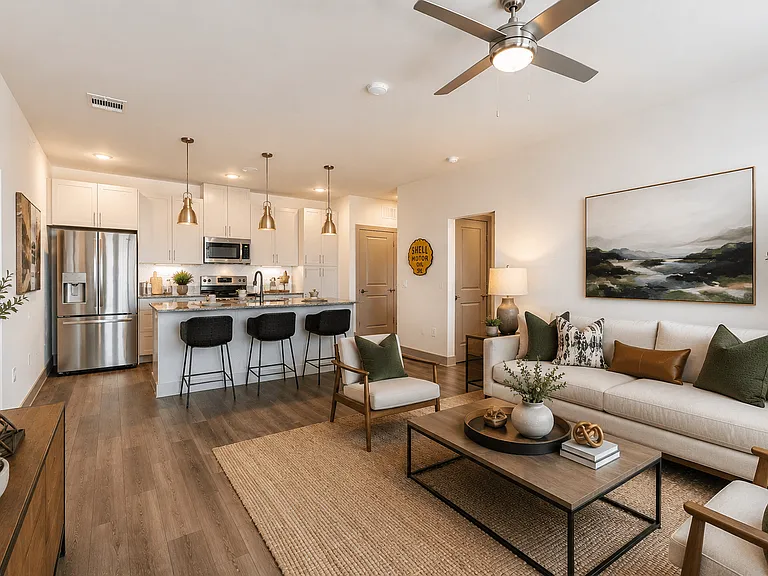 Spacious open-concept apartment featuring a designer kitchen with a large island and bright living area.