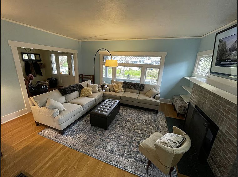 The living room offers a cozy, comfortable space with two large couches and a TV, perfect for unwinding after a long day (or night) of work. Kick back and relax in this inviting space designed for rest and relaxation.