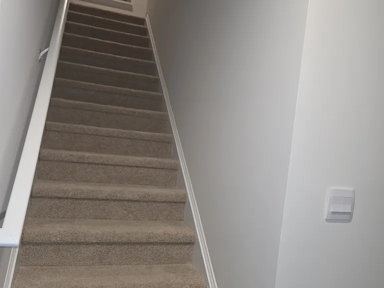 An extra window at the top of the stairs provides natural lighting upstairs