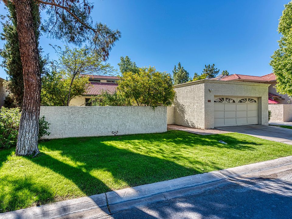 Front of home with walled and gated front patio