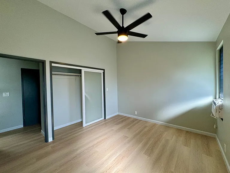 Bedroom #2 upstairs. Window AC, high ceilings and fan/light.