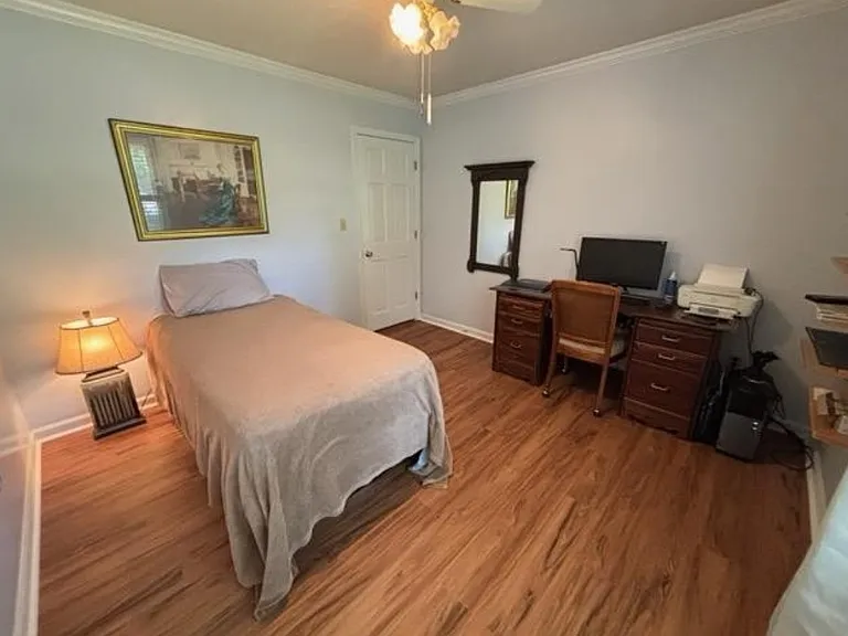 Third bedroom with built-in shelves, new luxury vinyl plank floor, plantation shutters