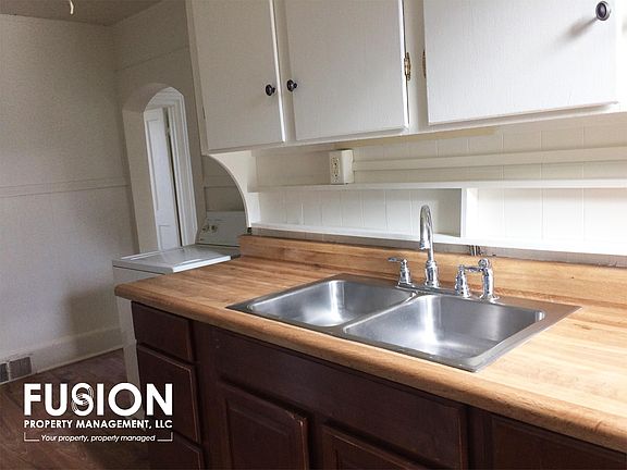 Bright galley kitchen with gas stove.