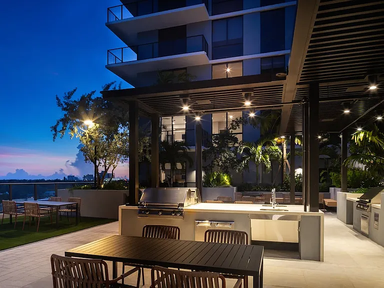 Outdoor lounge with BBQ grills and multiple seating areas