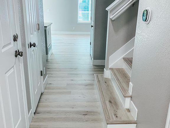 Entryway with brand new luxury vinyl flooring, new paint throughout, new baseboards.