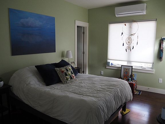 Bedroom with windows overlooking a beautiful, quiet yard.