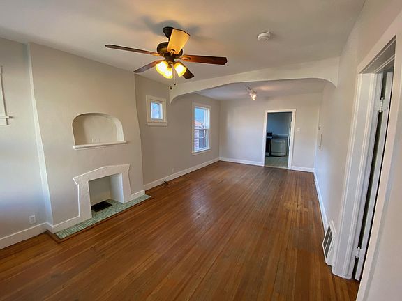 The living room has hardwood floors with old denver charm. The "candleplace" is a centerpiece of the living area and the back half is commonly used as a dining area.