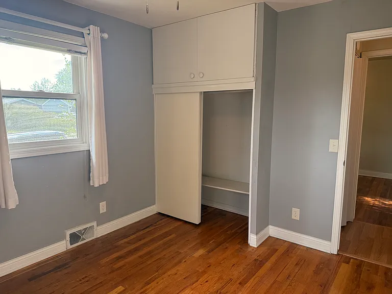 Bedroom 1, built-ins, new light, and ceiling fan.