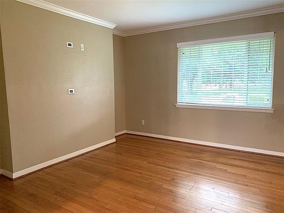 View of big double-paned window over looking front yard in living room.