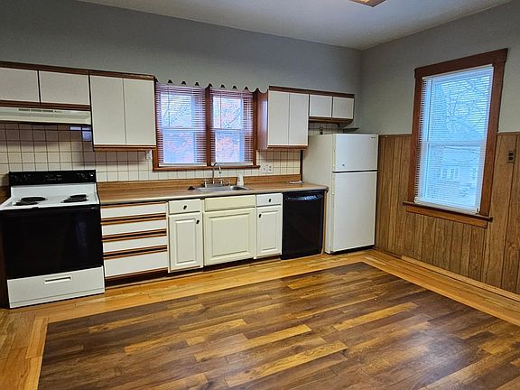 kitchen electric stove , garbage disposal, dishwasher and refrigerator.