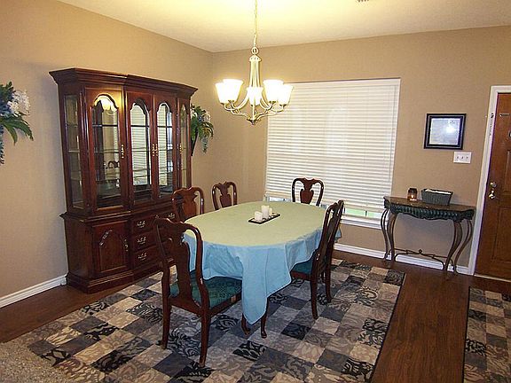Open Formal Dining Room with Laminate Flooring.