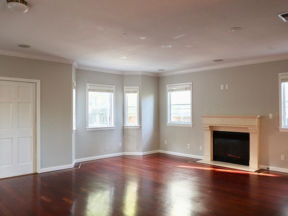 Open living room with hardwood floors and a gas fireplace
