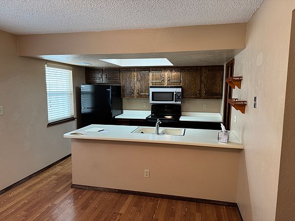 DINN WITH STACK BAR LOOKING INTO KITCHEN OFF TO RIGHT LARGE LAUNDRY ROOM