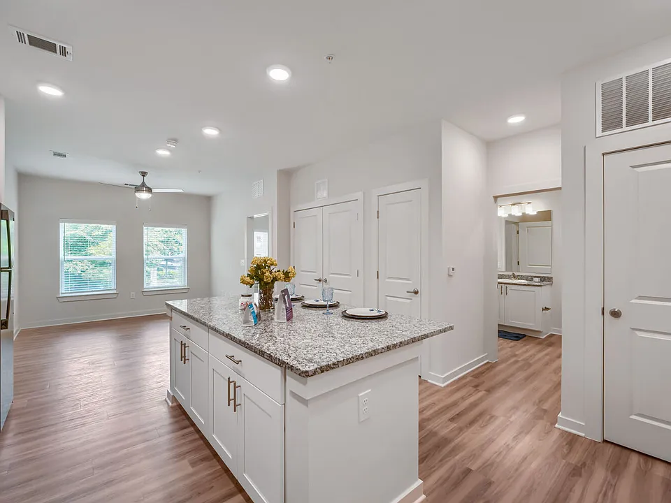 Kitchen with view of bathroom in the background