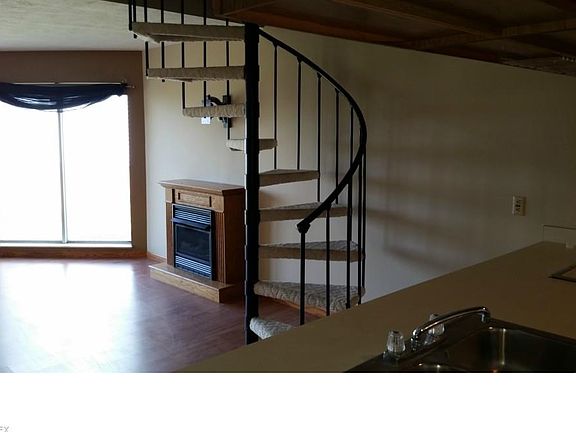 Living Room Gaas Fireplace, Ventless. and circular stairs.