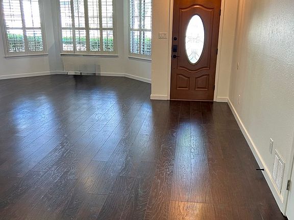 View from Dining Area to Front Door Entry and Living Room Alcove to the Side