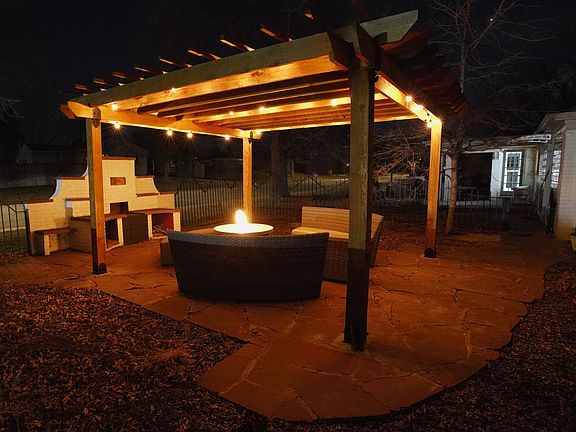 Courtyard with fireplace and woodburning stove. Patio furniture and fire table included.