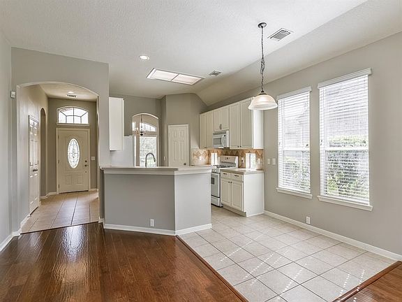 Open and light and bright kitchen with tiled breakfast area.  Tile and wood flooring add to this space and makes for great entertaining.  All new paint from baseboards to ceiling.