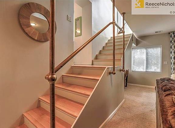 CONTEMPORARY WOOD STAIRCASE WITH BRASS HANDRAILS