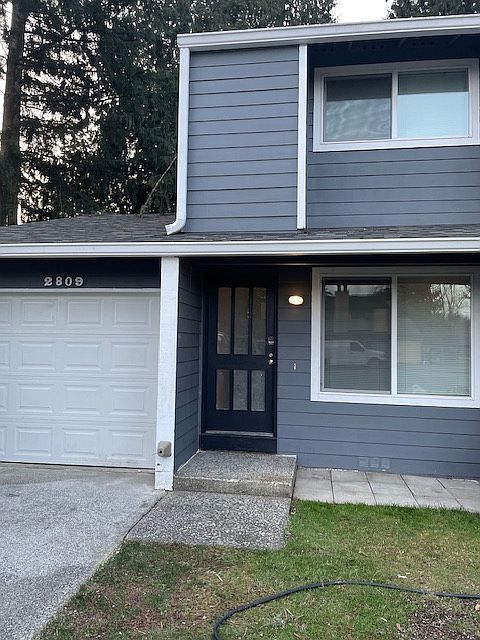 Front of home with 1 car garage- washer/dryer hook ups in garage