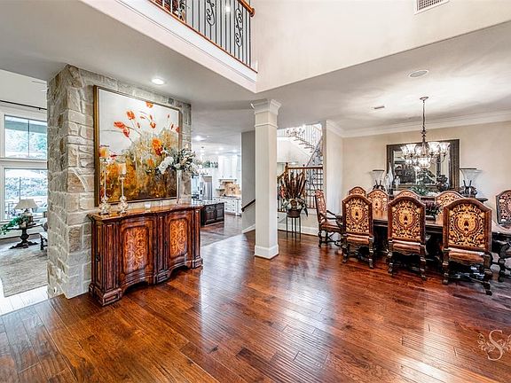 The dining room has views to the front as leaves fall from the mature trees or into the open living room.