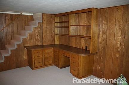 Den
						:
						Den/office in basement with built-in desk and book shelves.