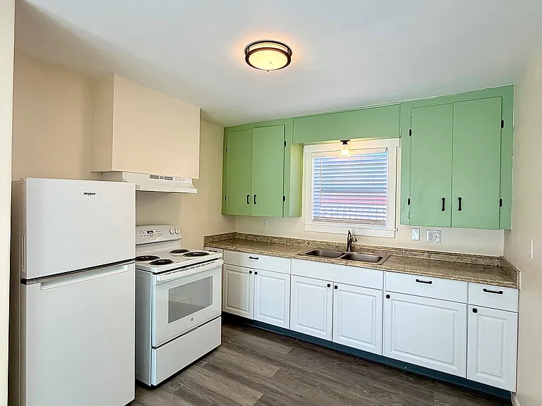 New green cabinets to brighten the kitchen space!