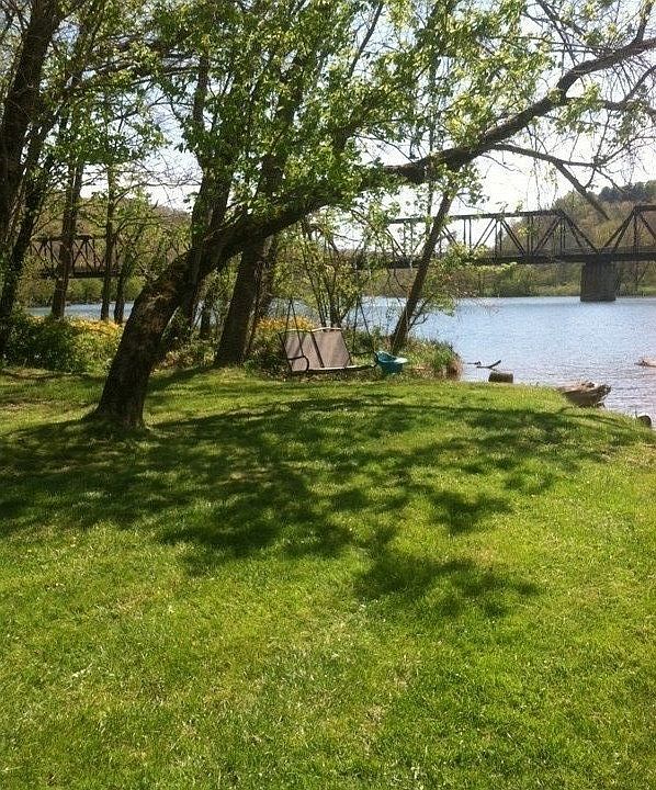 Unobstructed waterway view at shore
						:
						Perfect relaxation spot with swing and shade trees.