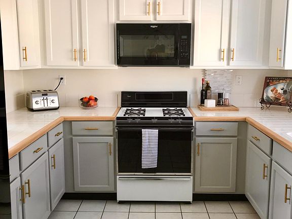Kitchen with newly refinished cabinets. Refeigerator, dishwasher, stove top, oven and microwave included
