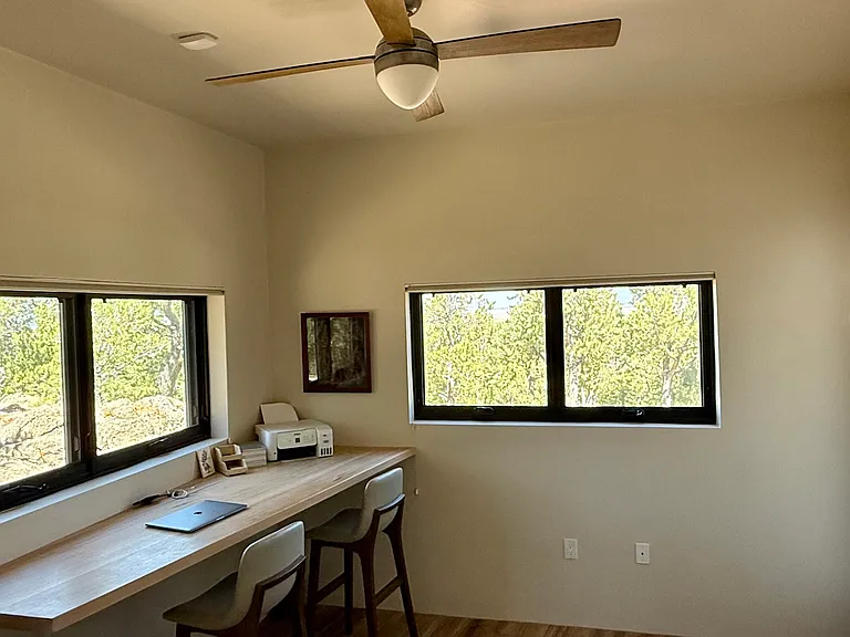 Quiet office with lots of natural light, awning windows with great views, and a door to the back deck