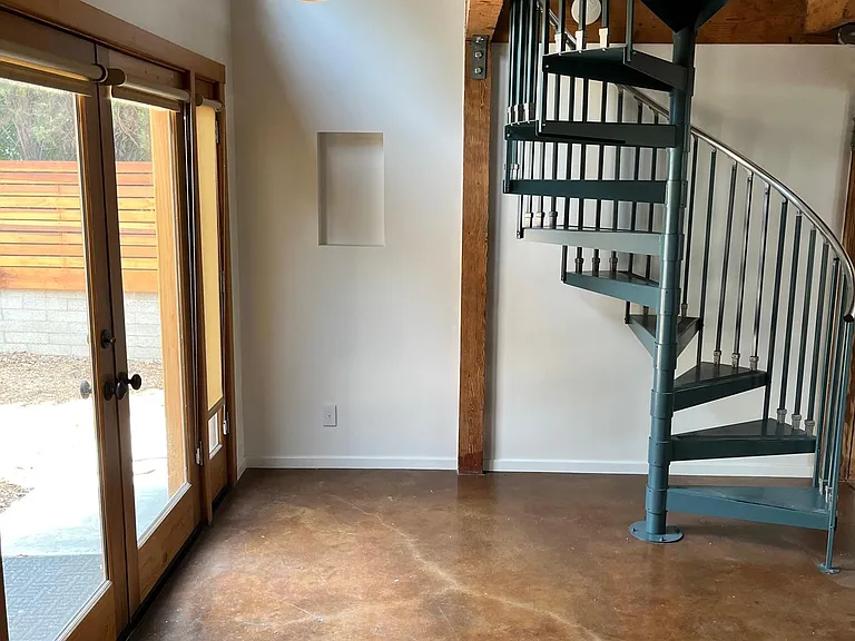 North entrance with spiral staircase leading to mezzanine.