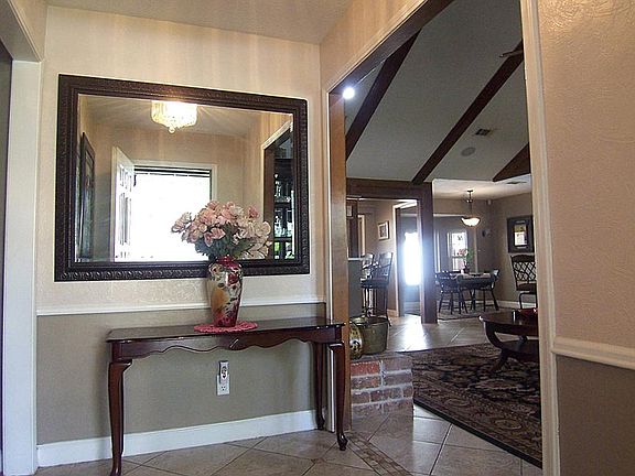 Nice, separate entry area with two tone paint and chair railing to invite guests in.