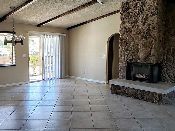 Living room/dining area with view of pool, mountains, lake