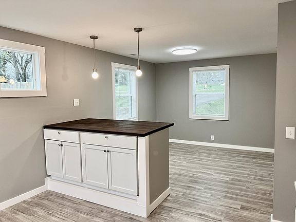 Great island with extra cabinets and drawers and pendent lights. Room for stools on the dining room side.